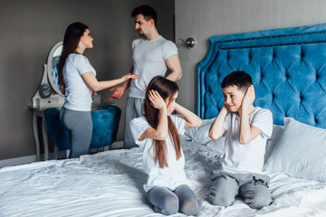 Little kids having problem  in bed caused by mom and dad arguing, family conflicts or divorce impact on child concept.