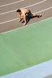 © LIGHTFIELD STUDIOS - overhead view of mixed race sportsman preparing to run at stadium