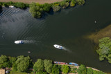 Fototapeta  - Overhead view of two boats and houses on the river Thames in Marlow, Buckinghamshire, UK