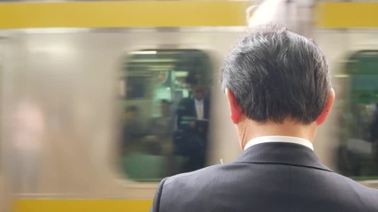 Canvas Print - POV a working man while wating for the arriving train at railway station in Tokyo,Japan./Japan Mass public  transportation