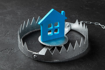 Trap with bait house. The risk of buying an old house. Dangerous mortgage. Home insurance. Black background.