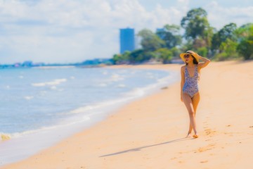 Portrait beautiful young asian woman happy smile relax on the tropical beach sea ocean for leisure travel