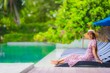 © siraphol - Portrait beautiful young asian woman happy smile relax in swimming pool at hotel resort neary sea ocean beach on blue sky