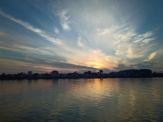 Wall Mural - the sky with the sun will rise in the river