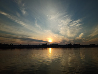 Wall Mural - the sky with the sun will rise in the river