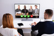 © Andrey Popov - Businesspeople Video Conferencing With Their Partner On Computer