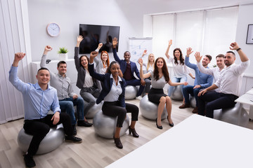 group of happy businesspeople waving hands