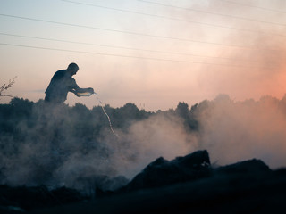 Fire in the field. Volunteers fighting the fire