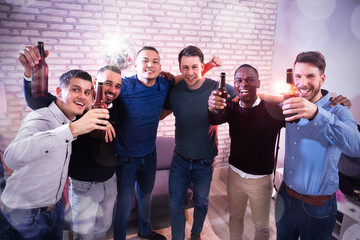 Portrait Of Men With Bottled Beer At Pub