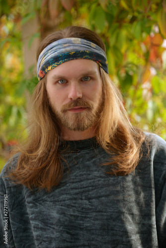 Portrait Of A Young Man With Long Hair And Beard In A Bandana