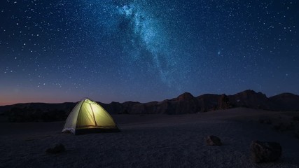 time-lapse overnight stay in a tourist tent on a starry night high in the mountains before dawn