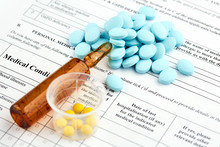 Brown Ampoule And Colorful Pills On Medical Questionnaire Form