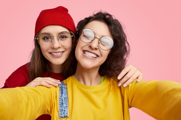 Wall Mural - cheerful girls taking selfie