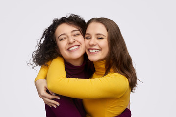 Wall Mural - best friends hugging and cheerfully smiling