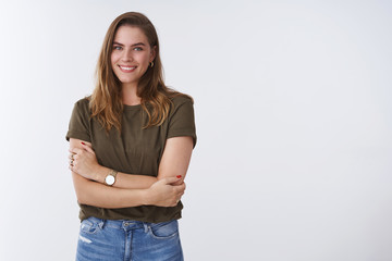 Wall Mural - Wellbeing people lifestyle concept. Charming feminine tender outgoing young woman wearing olive t-shirt cross arms chest smiling cute flirty expressing positivity joyful attitude, white background
