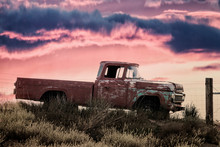 Vintage Pickup Truck On A Meadow At Sunset