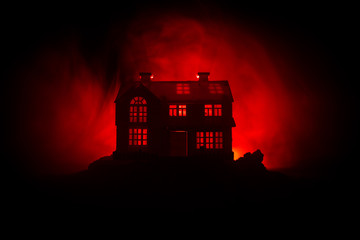 Wall Mural - old house with a ghost in the forest at night or abandoned haunted horror house in fog. old mystic b