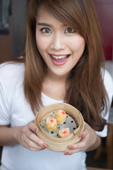 Wall Mural - woman eating Chinese Hong Kong dim sum