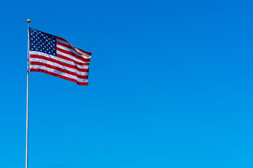 Fototapete - Flagstaff of United state of America on blue sky background,