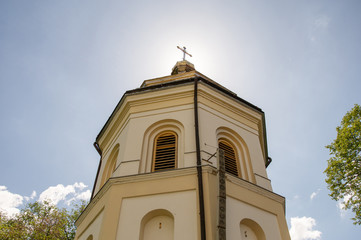 Church Bell Tower on the background of the sky, in the background of the sun.