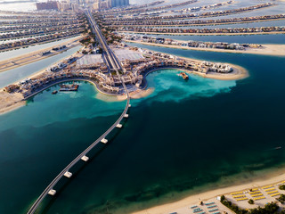 Wall Mural - The Palm monorail track leading into the island in Dubai aerial