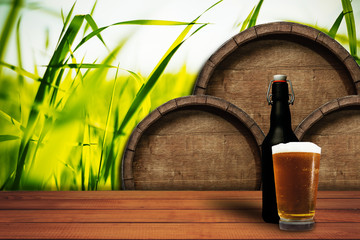 Poster - Wooden barrel background and glass of beer on a old oak table of wood.