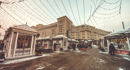 Naklejka na meble Christmas stalls in the square and Christmas tree. Outdoor vintage colorful carousel in the the city.  10.01.2019 Moscow, Russia