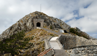 Wall Mural - LOVCEN, MONTENEGRO: People at the stairs to the tunnel on the way to the Njegos mausoleum in Lovcen mountain and national park in southwestern Montenegro.