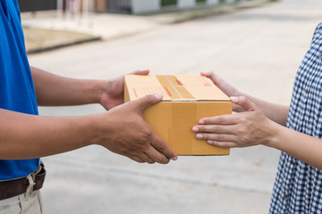 Women hands receiving package from delivery man.