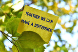 Fototapeta  - Word writing text Together We Can Make A Difference. Business photo showcasing be very important some way in like team or group Piece of square paper use to give notation on tree leaf under sunny day