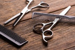 © fortton - Barber tool. Barber scissors. Scissors and hairbrush on vintage wooden background.