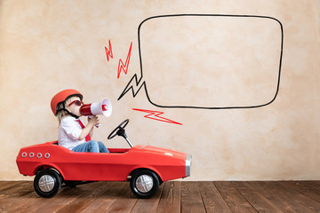 Canvas Print - Funny kid driving toy car at home