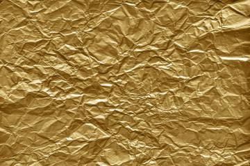 Canvas Print - crumpled gold foil paper texture. wrinkled shiny metallic surface background.