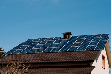 solar panel system on house roof, sunny blue sky background.blue solar panels.