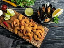 Fried Breaded Shrimps, Mussels Served With Lime On Wooden Board, Delicious Deep, Red, White Sauce
