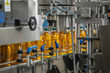 © DedMityay - Automatic conveyor belt of production line of juice on beverage plant or factory, modern computerized industrial equipment