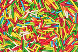 Fototapeta Tęcza - Abstract background of a variety of colorful sweet sticks used to decorate confectionery.