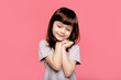© Marharyta Hanhalo - Cute pretty little caucasian girl wearing blank t-shirt over pink studio background. Human emotions, lifestyle, freestyle, smile, blank, funny gesture. Expressive and lovely face, natural beauty.