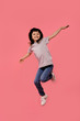© Marharyta Hanhalo - Full length body size view photo of lovely nice pretty little girl raise hands move movement enjoy free time weekend dressed checked modern stylish sneakers trousers isolated pink background