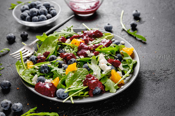 Summer salad with salad leaves, fruits, berries and cheese