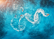 Aerial View Of Floating Water Scooter In Blue Water At Sunset In Summer. Holiday In Indian Ocean, Zanzibar, Africa. Top View Of Jet Ski In Motion. Tropical Seascape With Moving Motorboat. Extreme