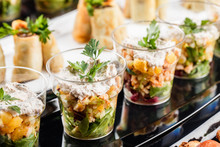 Delicious Appetizers With Salmon, Shrimp, Cheese And Greens In Glass Cups On Banquet Table. Gourmet Food Close Up, Snack, Antipasti, Seafood Platter