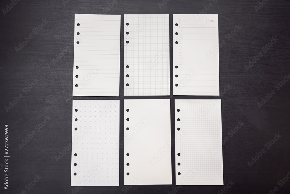 Different paper for notepad mocap on a black wooden background - obrazy, fototapety, plakaty 