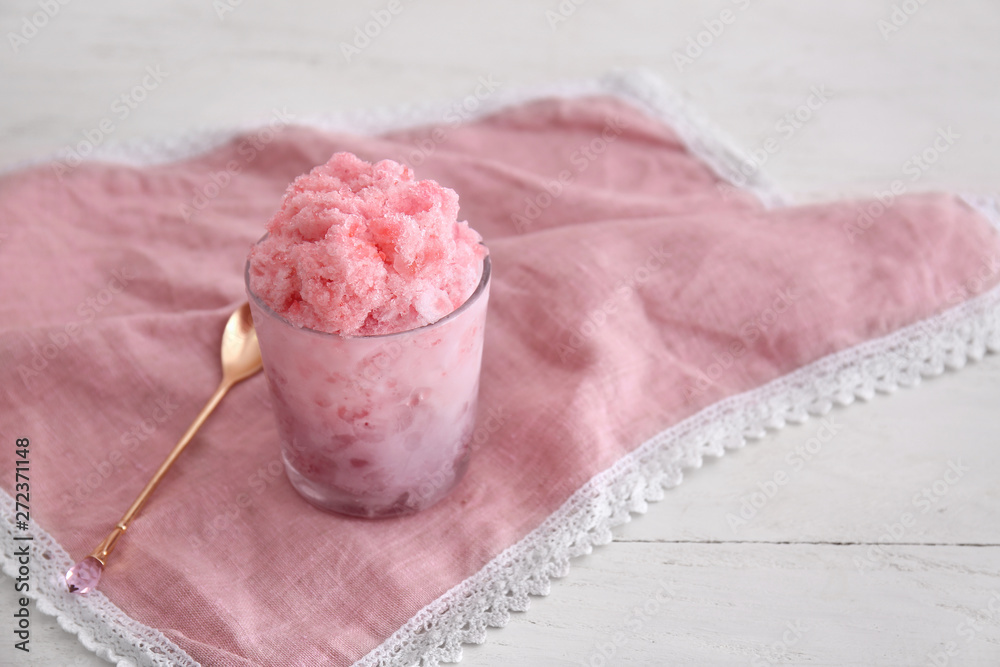 Glass with tasty shaved ice on table
