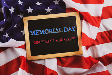 Wall Mural - Memorial day weekend text written on wooden black chalkboard with USA flag. United States of America stars & stripes patriot veteran remembrance symbol. Background, close up, copy space, top view.