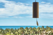 Wooden wind chime on the background of the sea and trees