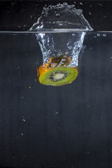  slice of kiwi falling in water