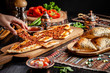 Traditional Turkish cuisine. Turkish pizza Pita with meat. Turk Pidesi or  Sucuk Pide. Beautiful serving dishes in the restaurant. Background image. copy space