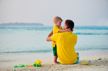 Wall Mural - Three year old toddler boy on beach with father. Summer family vacation at Maldives.