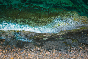 Wall Mural - Aerial view of rocky coastline and turquoise sea water